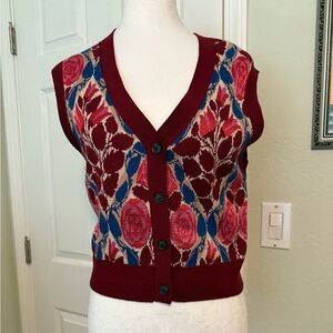 Maeve sweater vest in burgundy, blue, rose, and tan.